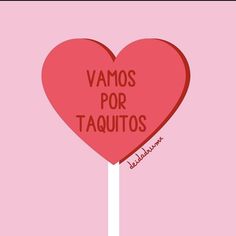 a heart shaped lollipop with the words vamos por taquitos written on it