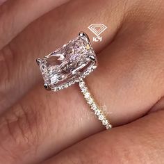 a woman's hand with a ring on it and a diamond in the middle