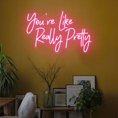 there is a neon sign that says you're like really pretty on the wall