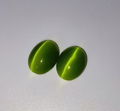 two green oval shaped objects on a white surface