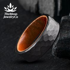 an image of a ring that is made out of wood and silver with the logo of the moso jewelry co on it