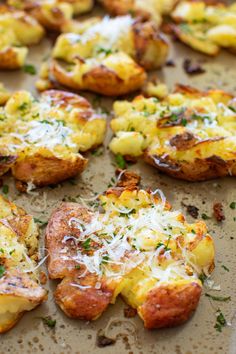 baked potato bites with cheese and parmesan on a baking sheet, ready to be eaten