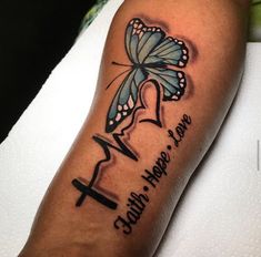 a butterfly with the words faith hope love and a cross on it's arm