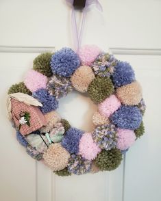 a knitted wreath hanging on the front door