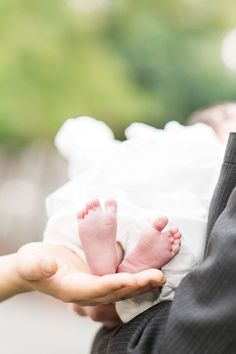 a person holding a baby in their hands