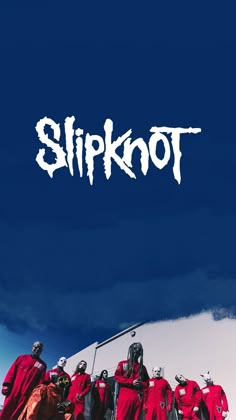 a group of people standing in front of a blue sky with the word slipknot on it