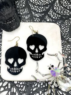 💀 Stand out with your statement earrings, these are fun and lightweight and sure to make any outfit pop! Perfect for Halloween time to wear and jazz up your costume or party outfits! Available in white, black, glitter silver, glitter gold, and glitter red! 💀 Length: 2"Width: 1.5" *♡* Please note that each item is handmade and colors may reflect slight differences than the ones pictured. Due to the delicate nature of the stones/rhinestones/beads, I am not responsible if you mishandle your earri Black Novelty Jewelry For Valentine's Day, Black Spooky Jewelry For Party, Black Spooky Party Jewelry, Spooky Black Jewelry For Party, Black Novelty Jewelry For Party, Black Novelty Jewelry For Costume Party, Novelty Black Jewelry For Party, Black Halloween Party Earrings, Edgy Black Earrings For Party