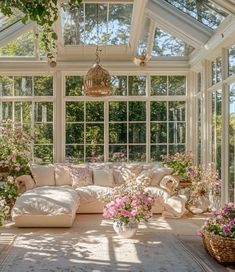 the sun room is filled with flowers and plants