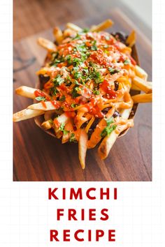 a wooden table topped with french fries covered in sauce