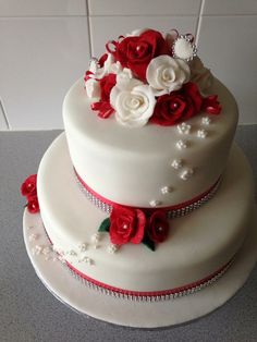 two tiered wedding cake with red and white flowers