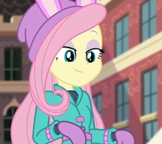 pinkie is standing in front of a building with her hair up and looking at the camera