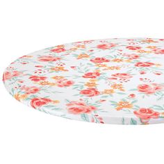 a white and red flowered round tablecloth on a white background with pink flowers