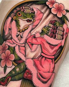 a woman in pink and green with flowers on her thigh, holding a frog's head