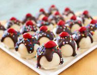 chocolate covered desserts with sprinkles on a white plate