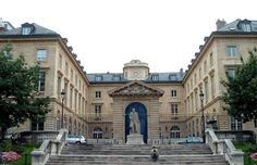 a large building with steps leading up to it and a statue on the front door