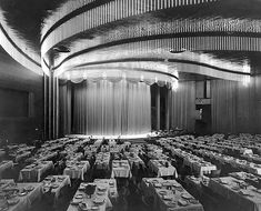 an old black and white photo of a banquet hall