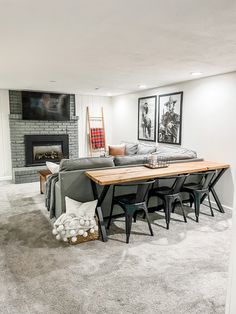 a living room filled with furniture and a fire place next to a wall mounted tv