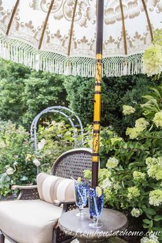 an umbrella sitting on top of a table next to flowers