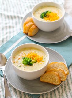 two bowls of soup with bread on the side