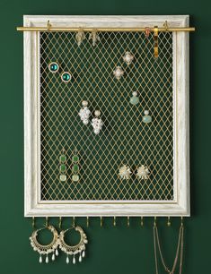 a wall mounted jewelry rack with earrings on it