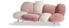 a pink and white couch sitting on top of a wooden frame