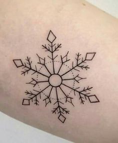 a snowflake tattoo on the arm