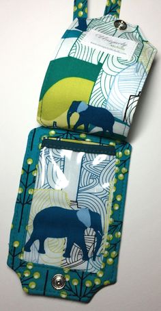 two small pouches with elephants on them, one is blue and the other is green