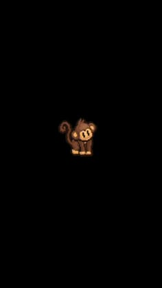 an animal is standing in the dark with its head turned to look like a monkey