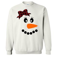 This Snowman With Buffalo Plaid Bow Tee is perfect for this holiday season and beyond. This festive design is a fun way to celebrate the winter season. With both youth and adult shirts available this is a super cute choice to pair with a pair of buffalo paid lounge pants for family Christmas lounge wear sets! This tee also pairs nicely with skinny jeans, vest, and booties for an adorable festive look.  GILDAN Short Sleeve - 6.0 oz. pre-shrunk 100% cotton Long Sleeve - 6.0 oz. pre-shrunk 100% cot Fun Winter T-shirt With Crew Neck, Funny White Winter T-shirt, Funny White T-shirt For Winter, Fun Winter Crew Neck T-shirt, Fun Crew Neck T-shirt For Winter, Fun Crew Neck Winter Tops, Fun White Christmas Tops, Fun Crew Neck Tops For Winter, Cute Winter Holiday Tops