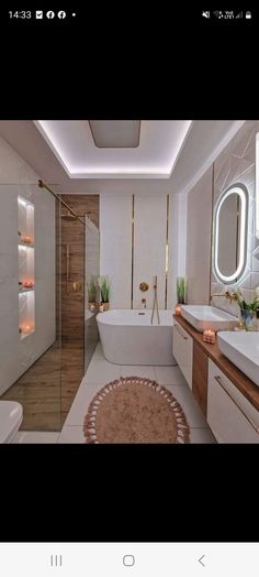 a bathroom with a bathtub, sink and toilet next to a mirror on the wall