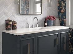 a bathroom vanity with two sinks and a large mirror over the sink in front of it