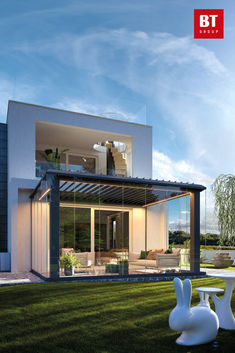 an image of a modern house that is in the grass with white chairs and tables