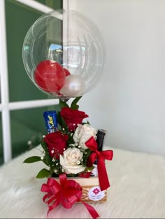 a vase filled with flowers and balloons on top of a table