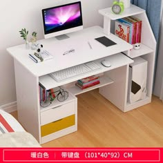 a white desk with a computer on it and bookshelves below the desk, in front of a window