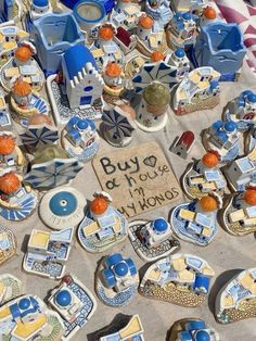 blue and white ceramic items on display at an outdoor flea market, with a sign that says buy more now