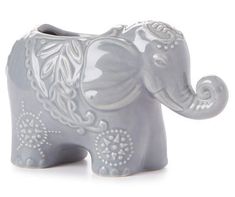 an elephant figurine is shown on a white background