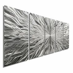 three metal wall art pieces with white and silver designs on the sides, one has an abstract