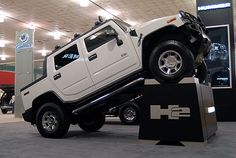 a white hummer truck on display in a showroom