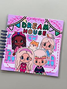 a spiral notebook with the words dream house on it and three cartoon characters in front