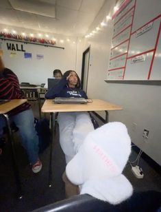 a person sitting at a table with a laptop