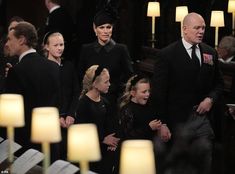 a group of people standing next to each other in front of candles and microphones