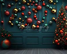 christmas decorations hanging on the wall in front of a green door with red and gold ornaments