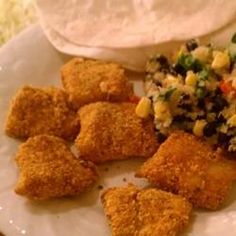 some fried food on a white plate with sauce