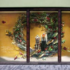 the window display is decorated with wreaths and birds