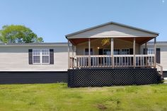 a mobile home sits in the middle of a grassy area