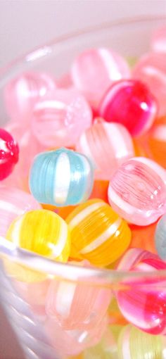 a bowl filled with colorful candies sitting on top of a table