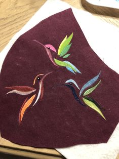 a piece of cloth with birds painted on it