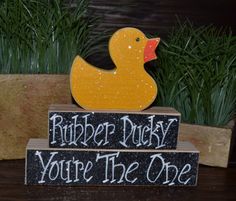 rubber ducky you're the one sign sitting on top of a wooden block