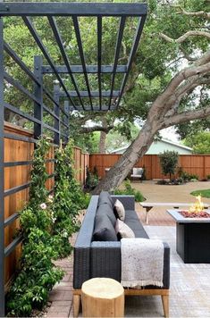 an outdoor living area with couches and fire pit