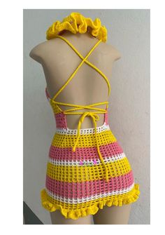 a mannequin wearing a yellow and pink crochet swimsuit